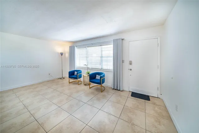 a view of a room with gym equipment and windows