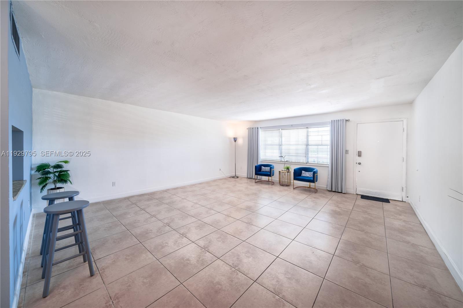 1855 Northeast 121st Street, Unit 32 North Miami, FL 33181 - Photo 5 of 22 a view of an empty room with a window
