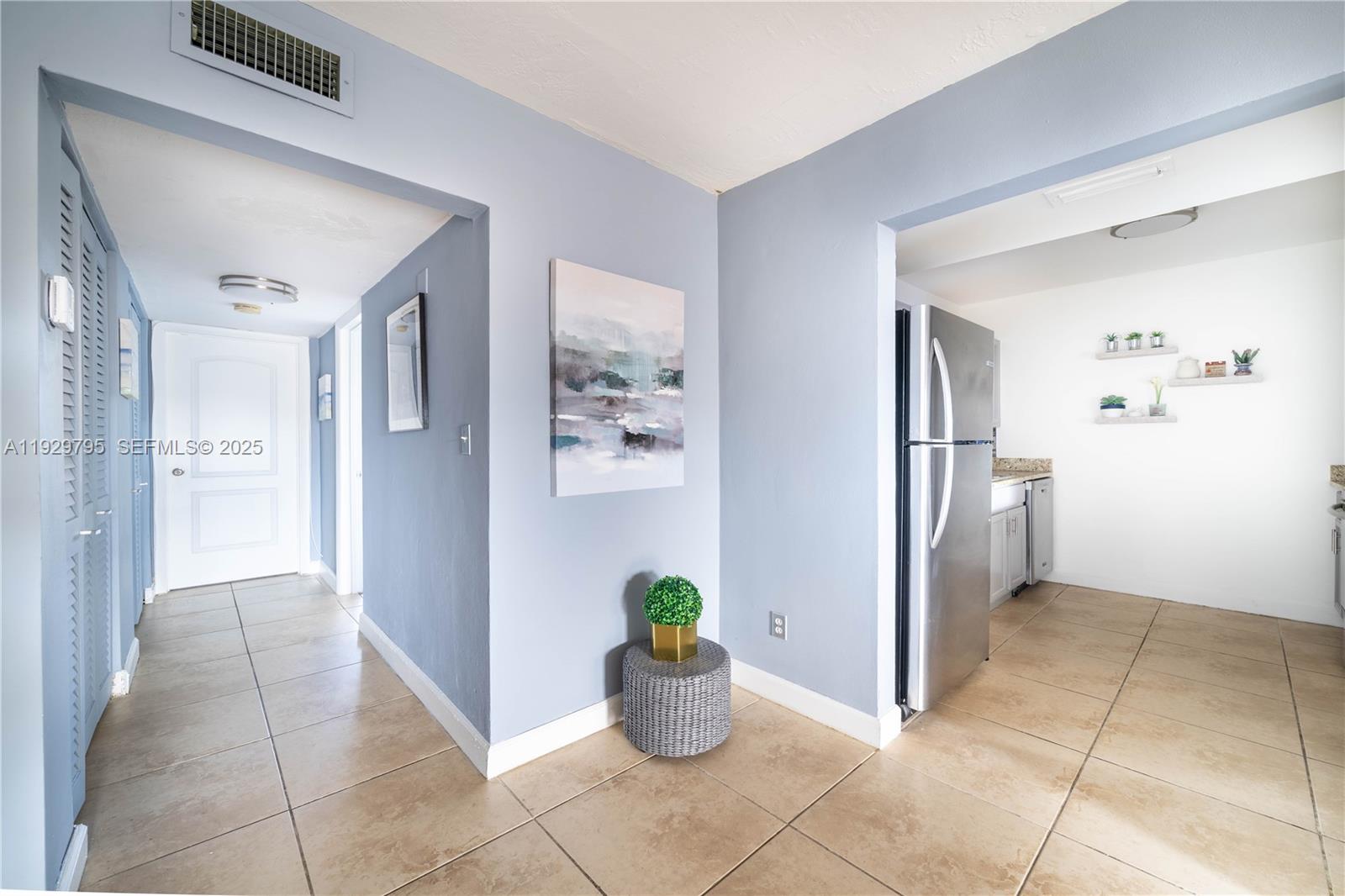1855 Northeast 121st Street, Unit 32 North Miami, FL 33181 - Photo 9 of 22 a view of a hallway with dining area