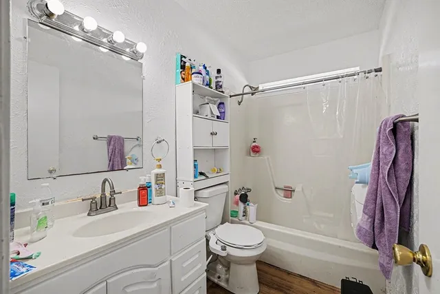 a bathroom with a sink toilet and shower