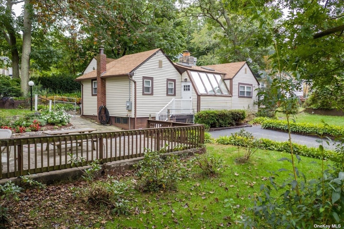 a view of a house with yard and a garden