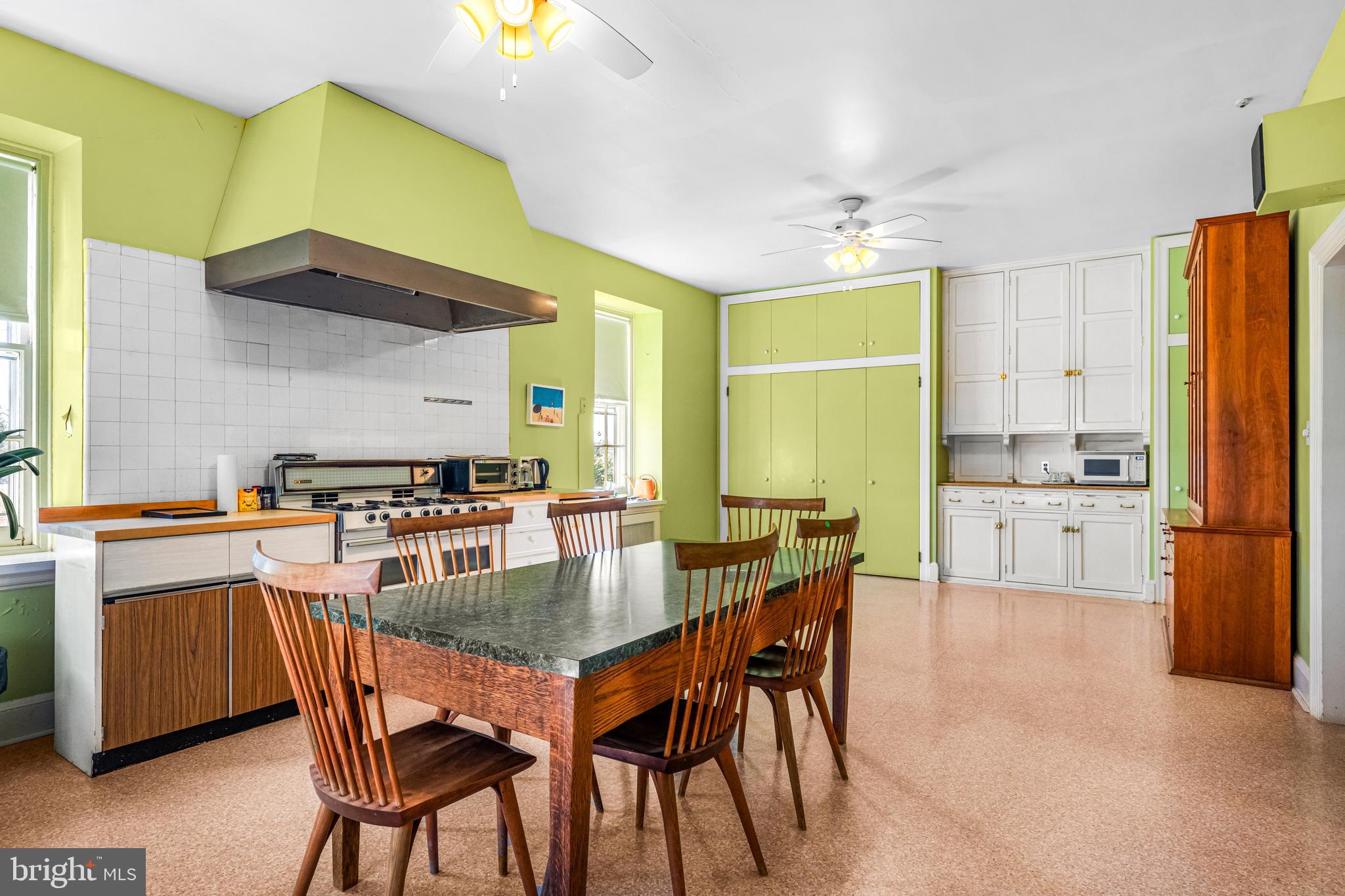 705 Church Road Villanova, PA 19085 - Photo 21 of 54 a kitchen with stainless steel appliances kitchen island granite countertop a table chairs sink and cabinets
