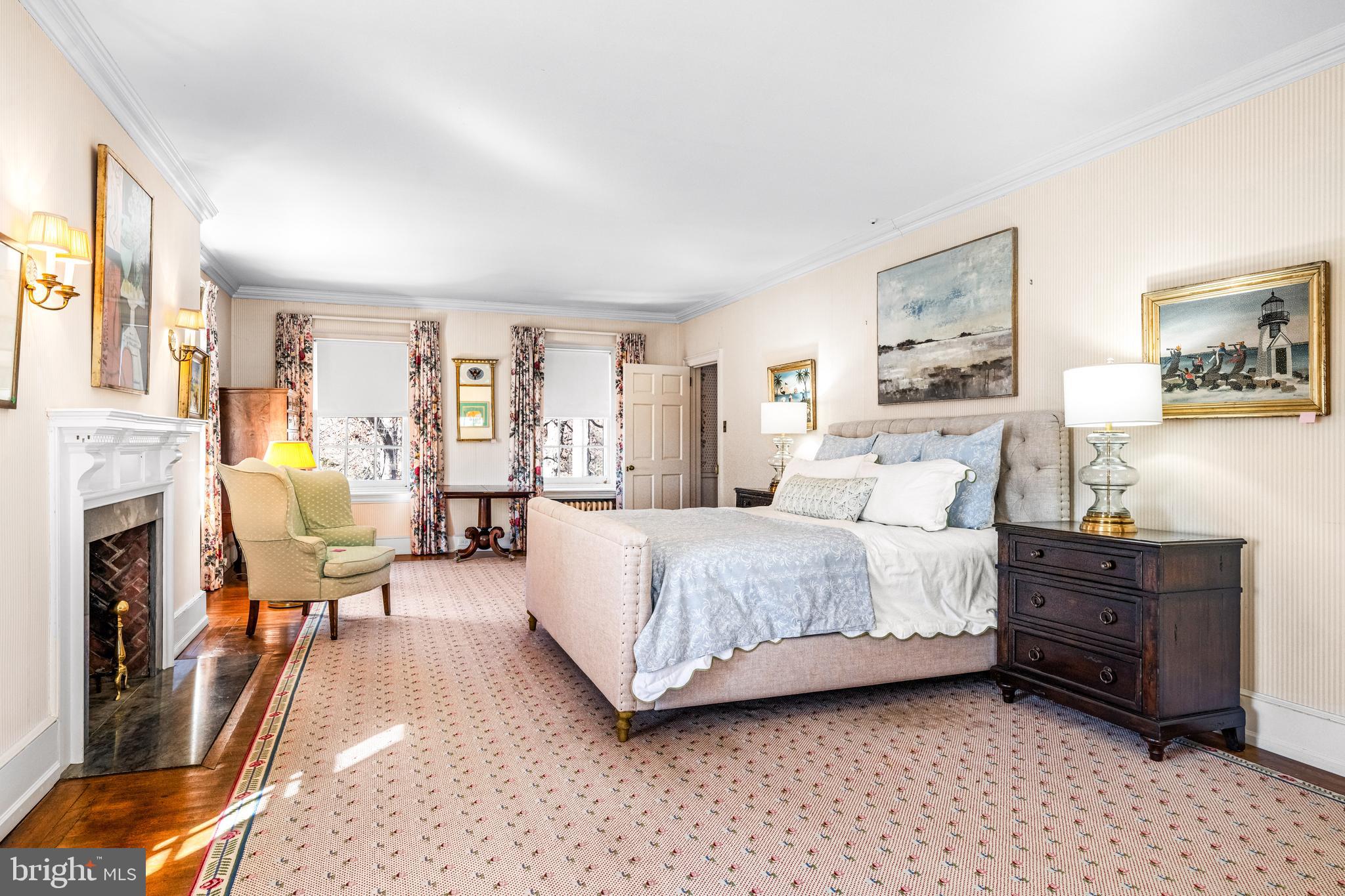 705 Church Road Villanova, PA 19085 - Photo 26 of 54 a spacious bedroom with a bed couch and a view of living room
