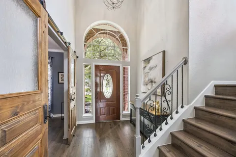 a view of an entryway with wooden floor