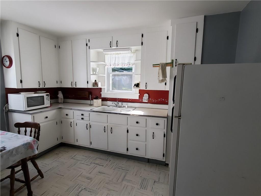 377 Fairview Road Fredonia, PA 16124 - Photo 8 of 27 a kitchen with granite countertop cabinets and white appliances