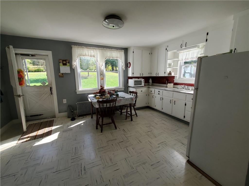 377 Fairview Road Fredonia, PA 16124 - Photo 9 of 27 a kitchen with sink cabinets and outdoor space