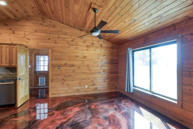 a view of an empty room with a ceiling fan