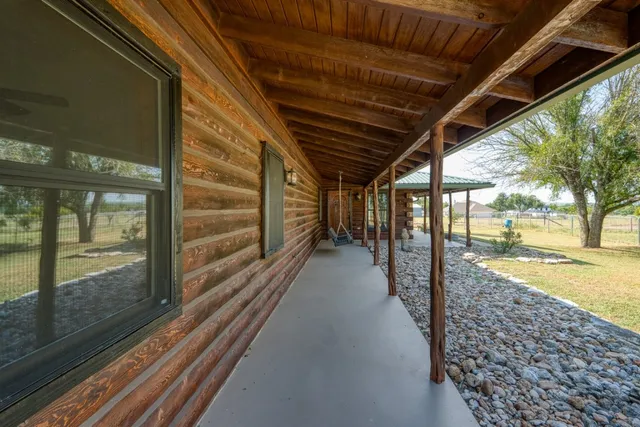 a view of a house with a yard and tree s