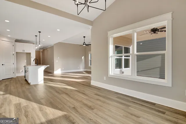 a view of kitchen with cabinets and refrigerator