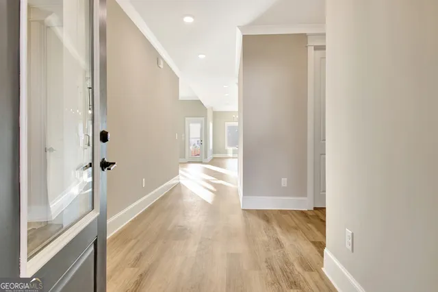 a view of hallway with wooden floor