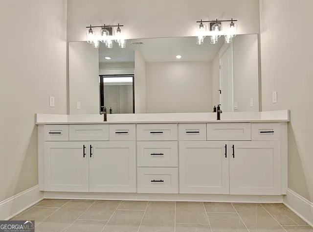 a bathroom with a glass shower door