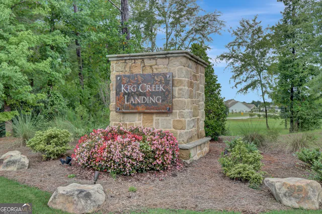 a view of a house with a big yard and large trees