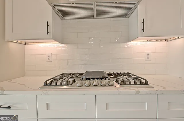 a kitchen with stainless steel appliances a white stove top oven and a refrigerator