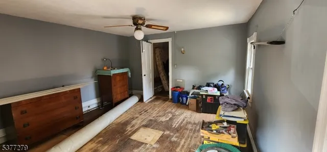 a bed room with furniture and wooden floor