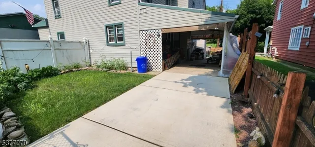 a view of a house with backyard and porch