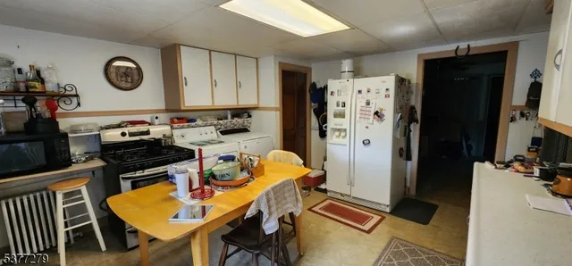 a kitchen with a refrigerator and a stove top oven