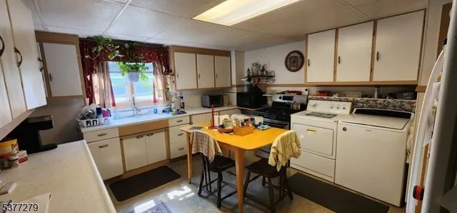 a kitchen with a sink appliances and cabinets