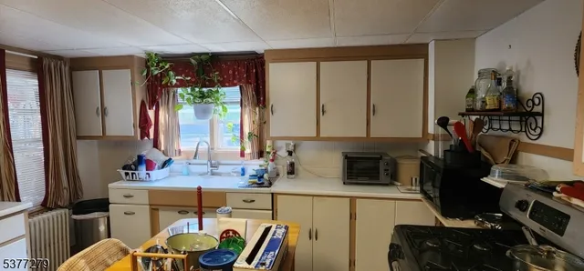 a kitchen with a sink stove and cabinets