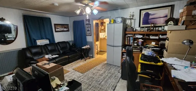 a living room with furniture a lamp and a flat screen tv