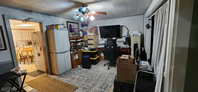 a view of a workspace with furniture and a window