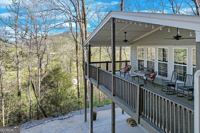 a view of a porch with wooden floor and iron fence