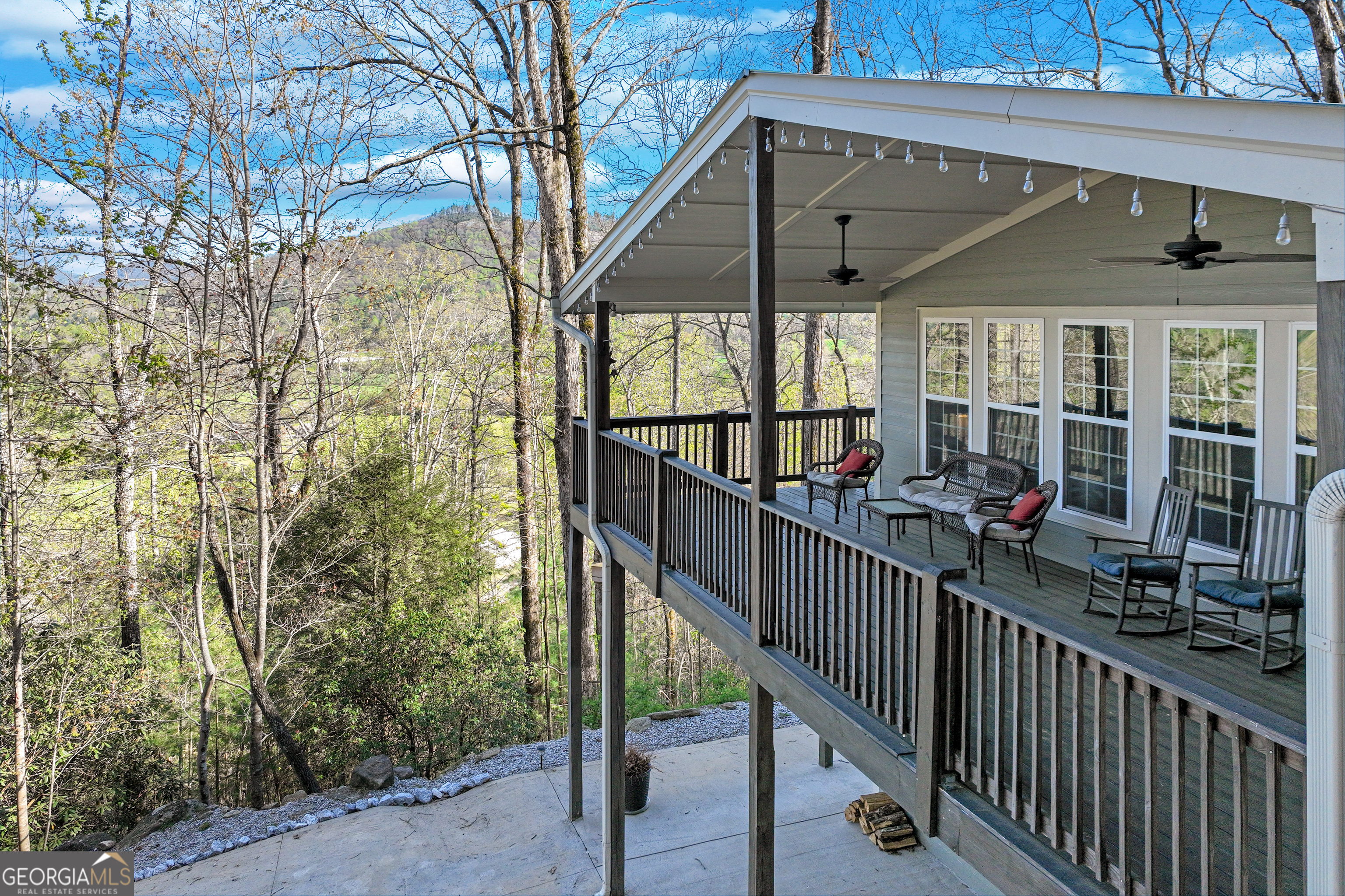 a view of a porch with wooden floor and iron fence