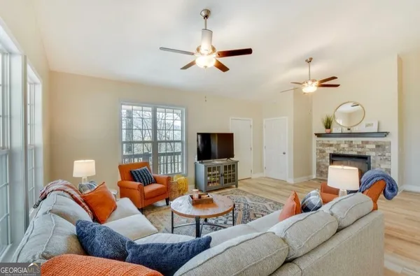 a living room with furniture a fireplace and a flat screen tv