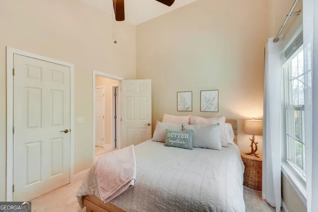 a bedroom with a bed and painting on the wall