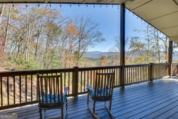 a view of wooden balcony with furniture