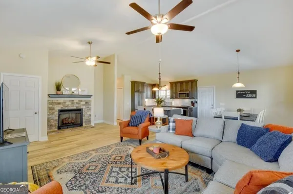 a living room with furniture a fireplace and a chandelier