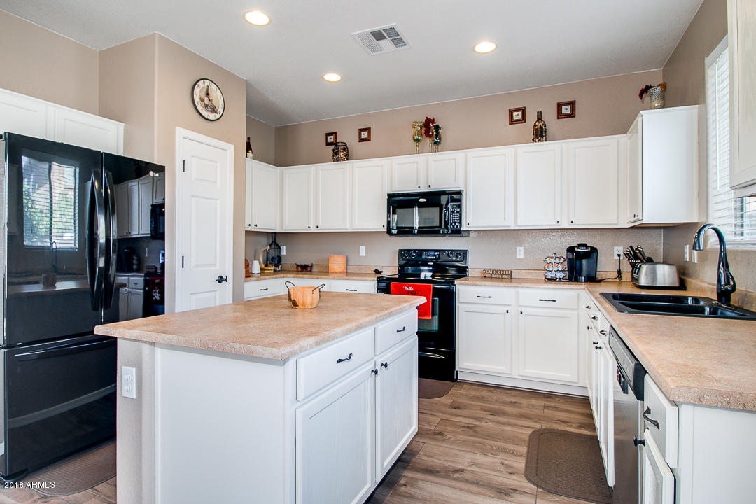 3954 East Morelos Street Gilbert, AZ 85295 - Photo 11 of 31 a kitchen with stainless steel appliances granite countertop a sink stove and refrigerator