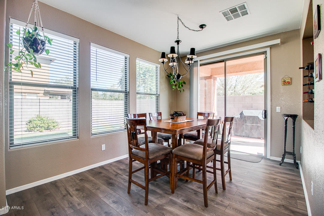 3954 East Morelos Street Gilbert, AZ 85295 - Photo 14 of 31 a view of a dining room with furniture window and wooden floor