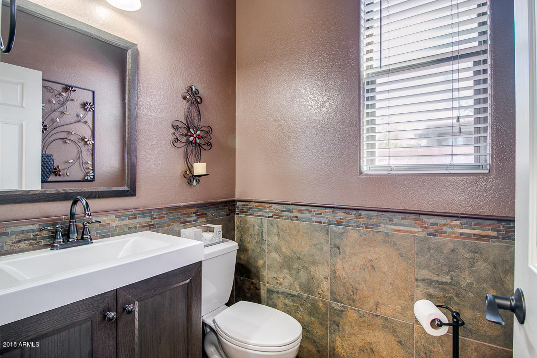3954 East Morelos Street Gilbert, AZ 85295 - Photo 15 of 31 a bathroom with a sink mirror vanity and toilet