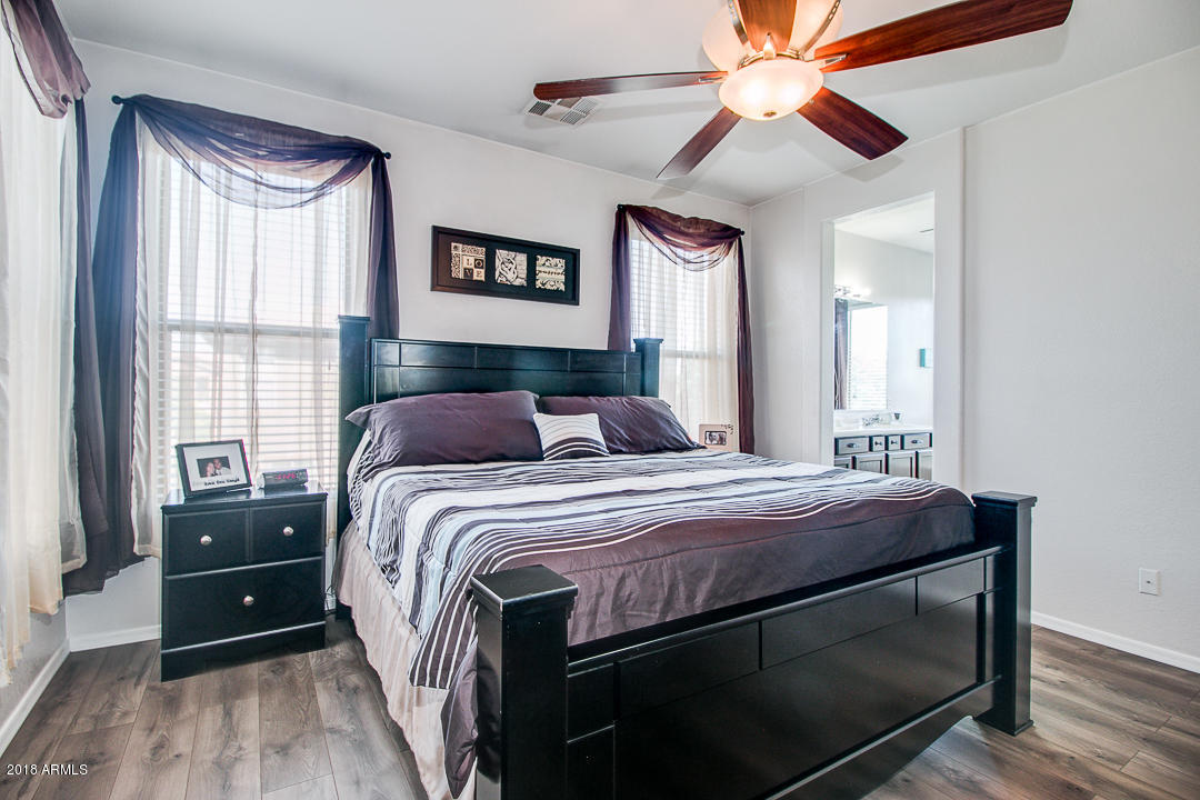 3954 East Morelos Street Gilbert, AZ 85295 - Photo 17 of 31 a bedroom with a bed and a ceiling fan