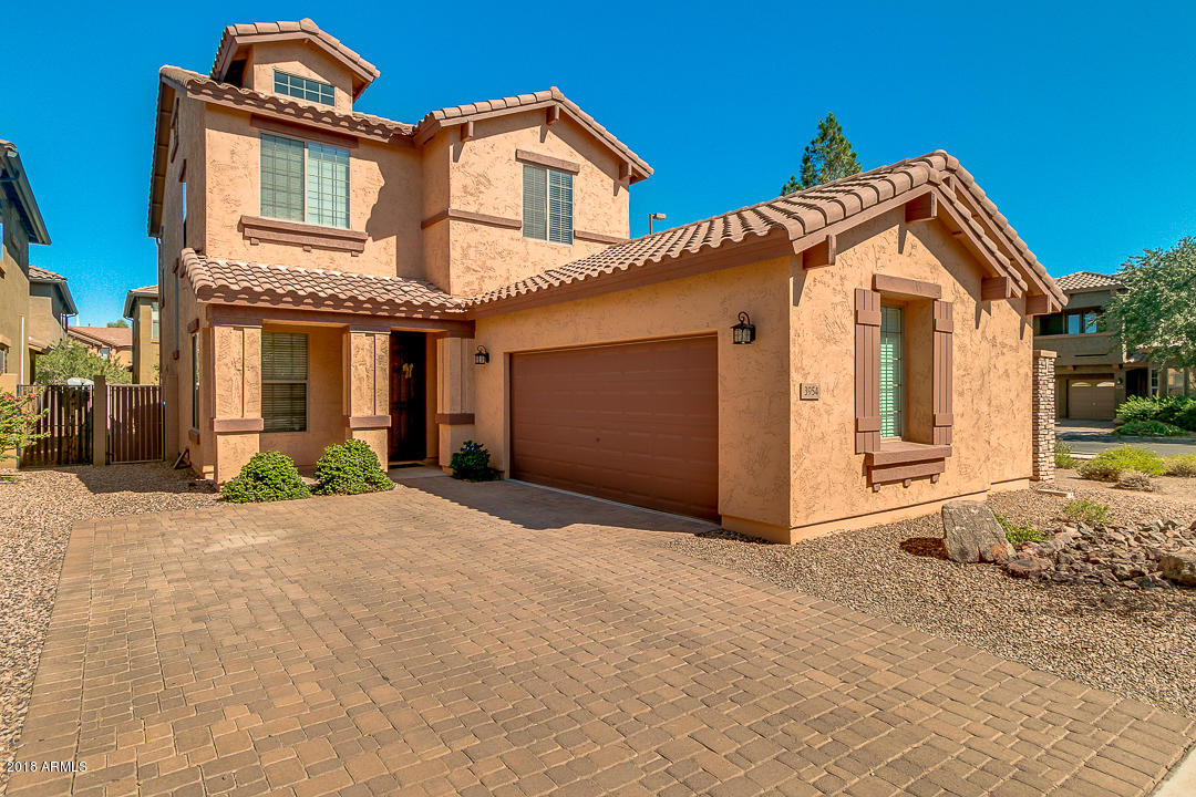 3954 East Morelos Street Gilbert, AZ 85295 - Photo 2 of 31 a front view of a house with a yard and garage