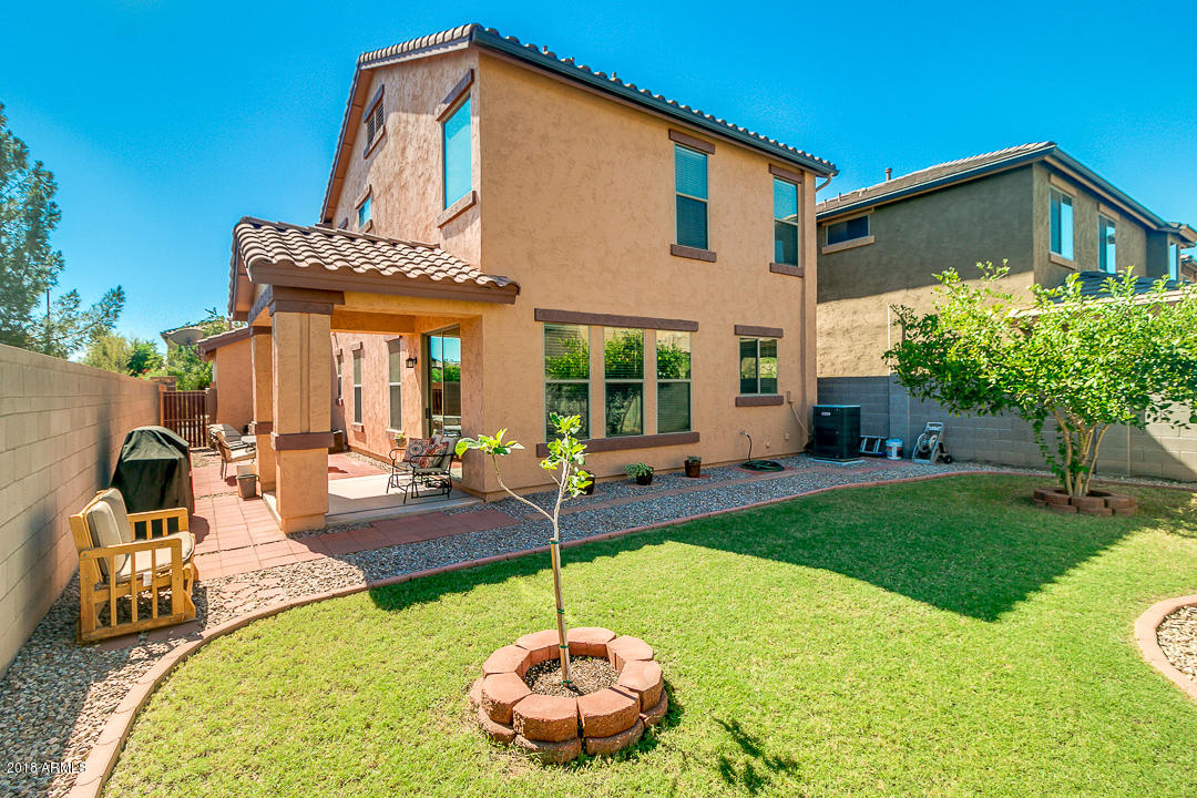 3954 East Morelos Street Gilbert, AZ 85295 - Photo 29 of 31 a front view of a house with swimming pool table and chairs