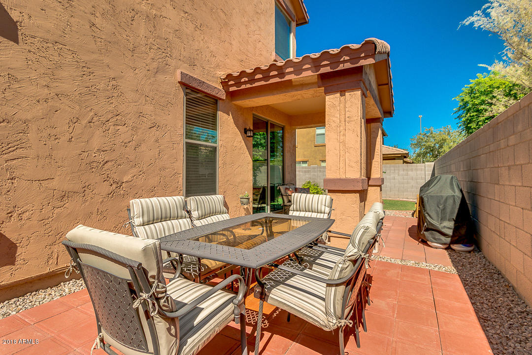 3954 East Morelos Street Gilbert, AZ 85295 - Photo 30 of 31 a view of a patio with table and chairs and potted plants