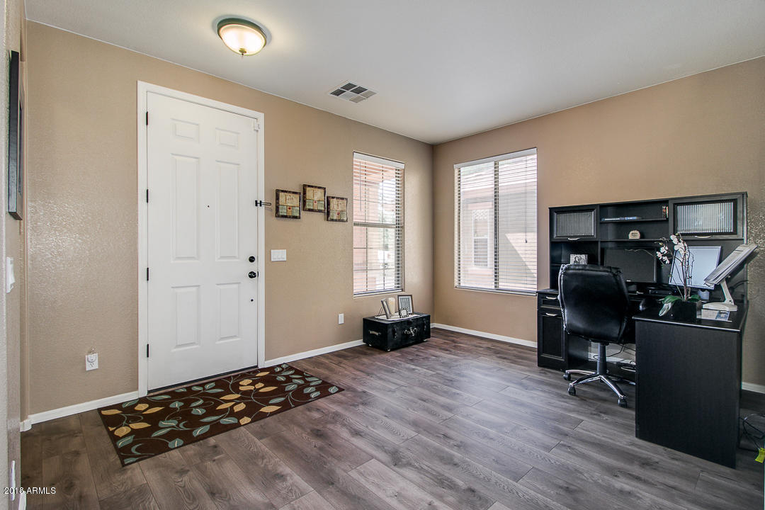 3954 East Morelos Street Gilbert, AZ 85295 - Photo 4 of 31 a bedroom with a bed and wooden floor