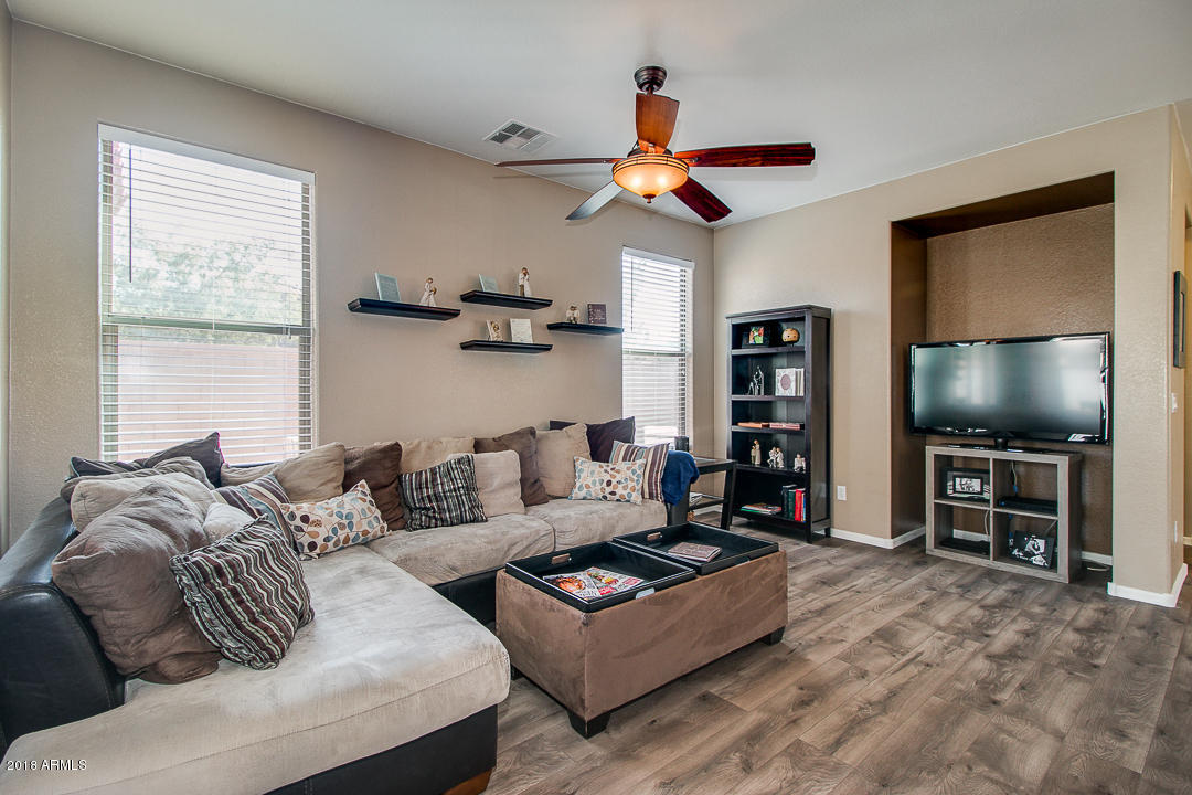 3954 East Morelos Street Gilbert, AZ 85295 - Photo 7 of 31 a living room with furniture a flat screen tv and a window