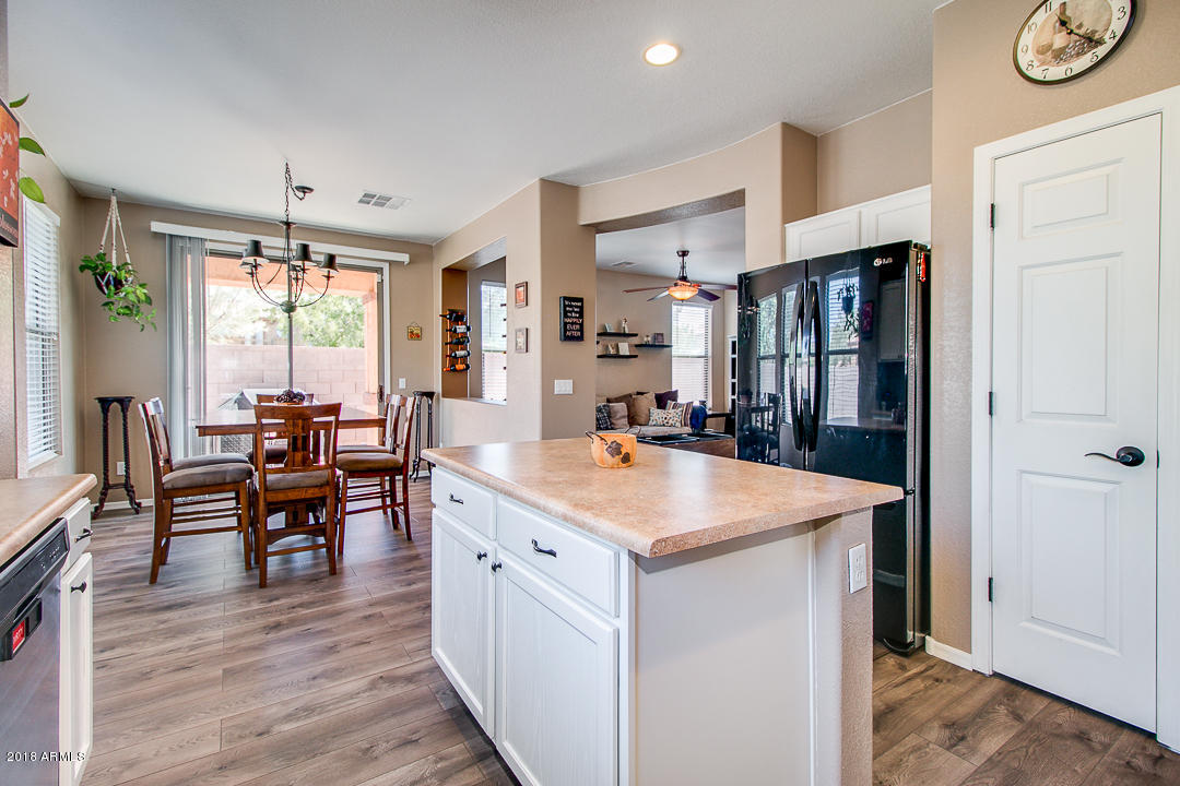 3954 East Morelos Street Gilbert, AZ 85295 - Photo 9 of 31 a open kitchen with stainless steel appliances granite countertop a stove and refrigerator