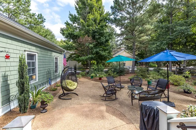 a living room with furniture a large window and a fireplace