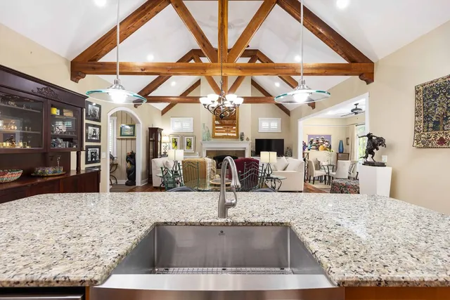 a living room with furniture a fireplace and a large window