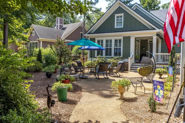 a view of a patio with chairs and plants