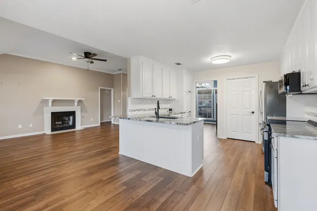 a kitchen with a refrigerator and a fireplace