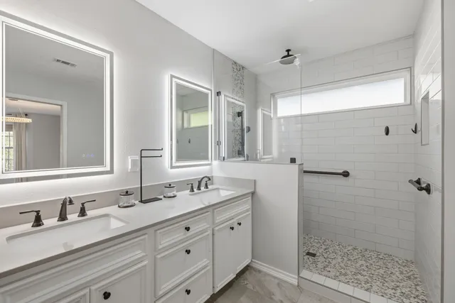 a bathroom with double sink and a mirror