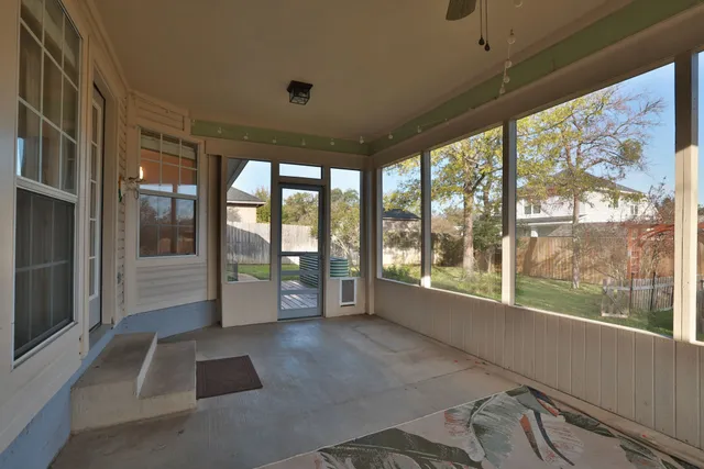 a room with large windows and a table