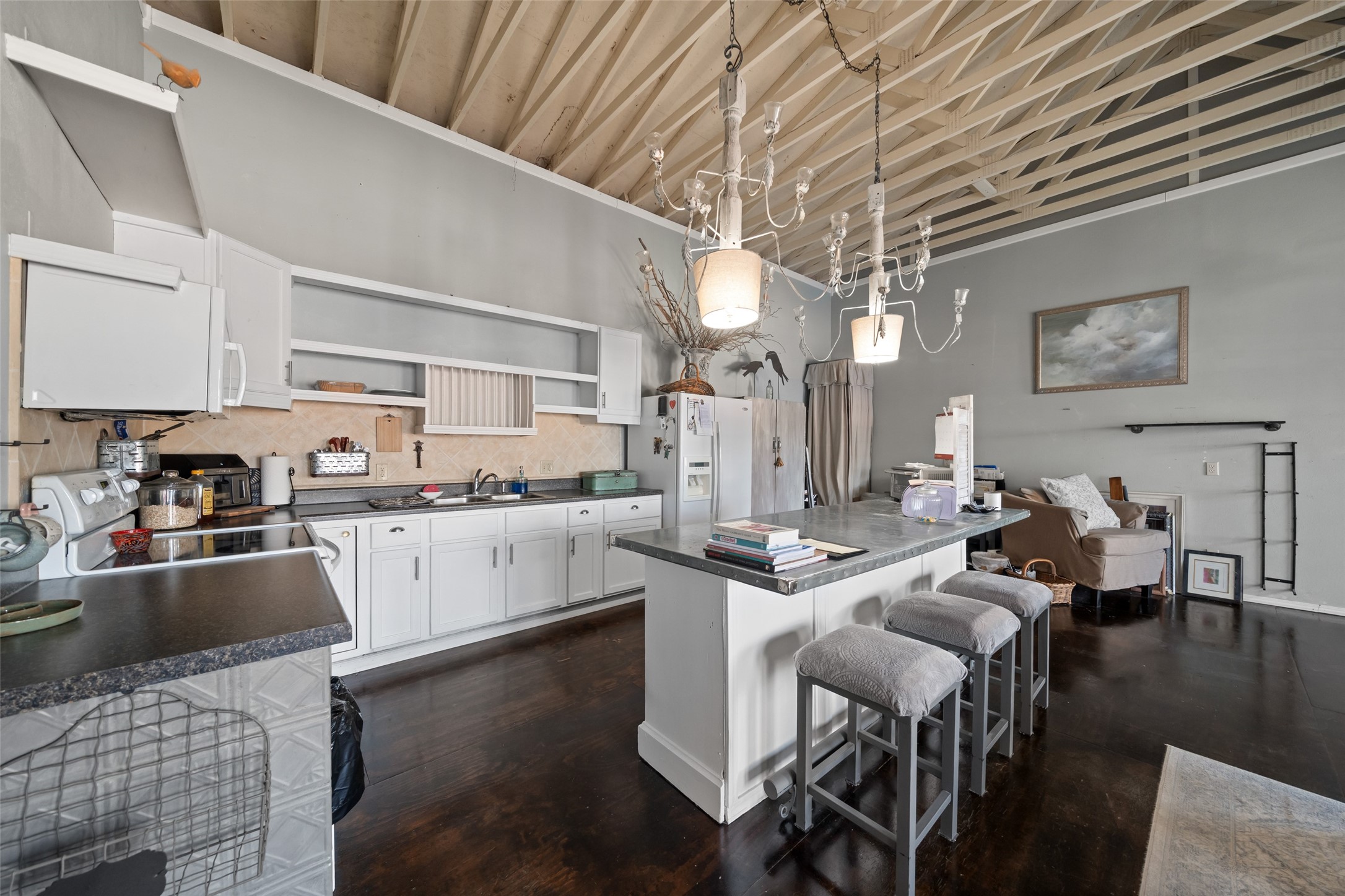 26407 Preston Avenue Spring, TX 77373 - Photo 20 of 38 a kitchen with stainless steel appliances granite countertop a sink dishwasher a stove a refrigerator a dining table and chairs with wooden floor