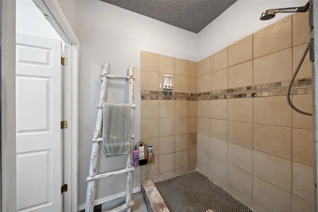 a bed sitting in a spacious bedroom next to a window