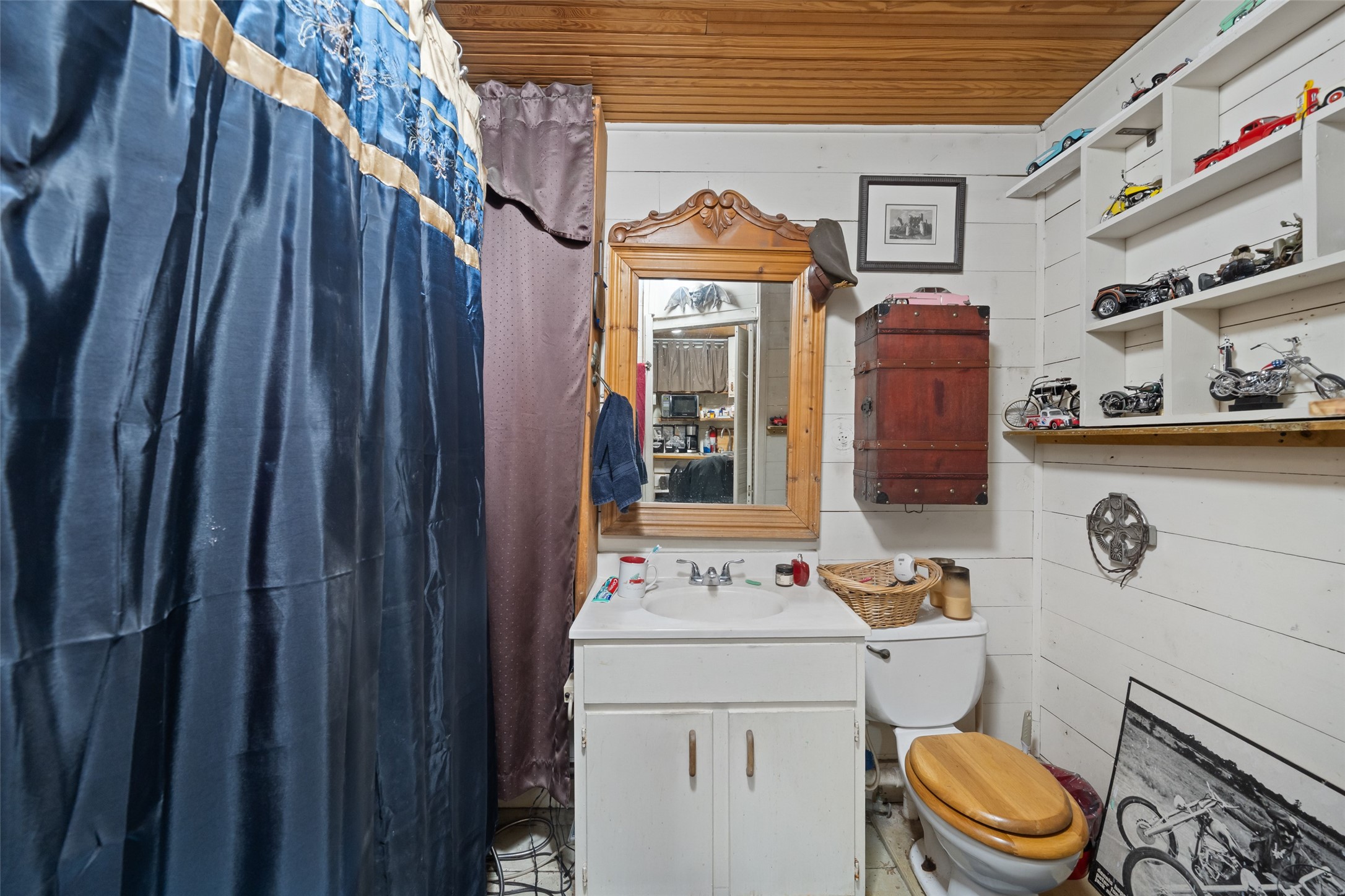 26407 Preston Avenue Spring, TX 77373 - Photo 32 of 38 a bathroom with a sink a toilet and shower curtain