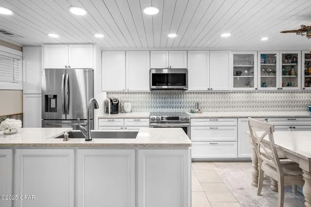 a kitchen with a sink and a refrigerator